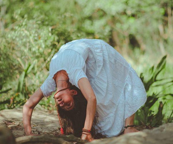 Person meditating peacefully in a serene natural environment.